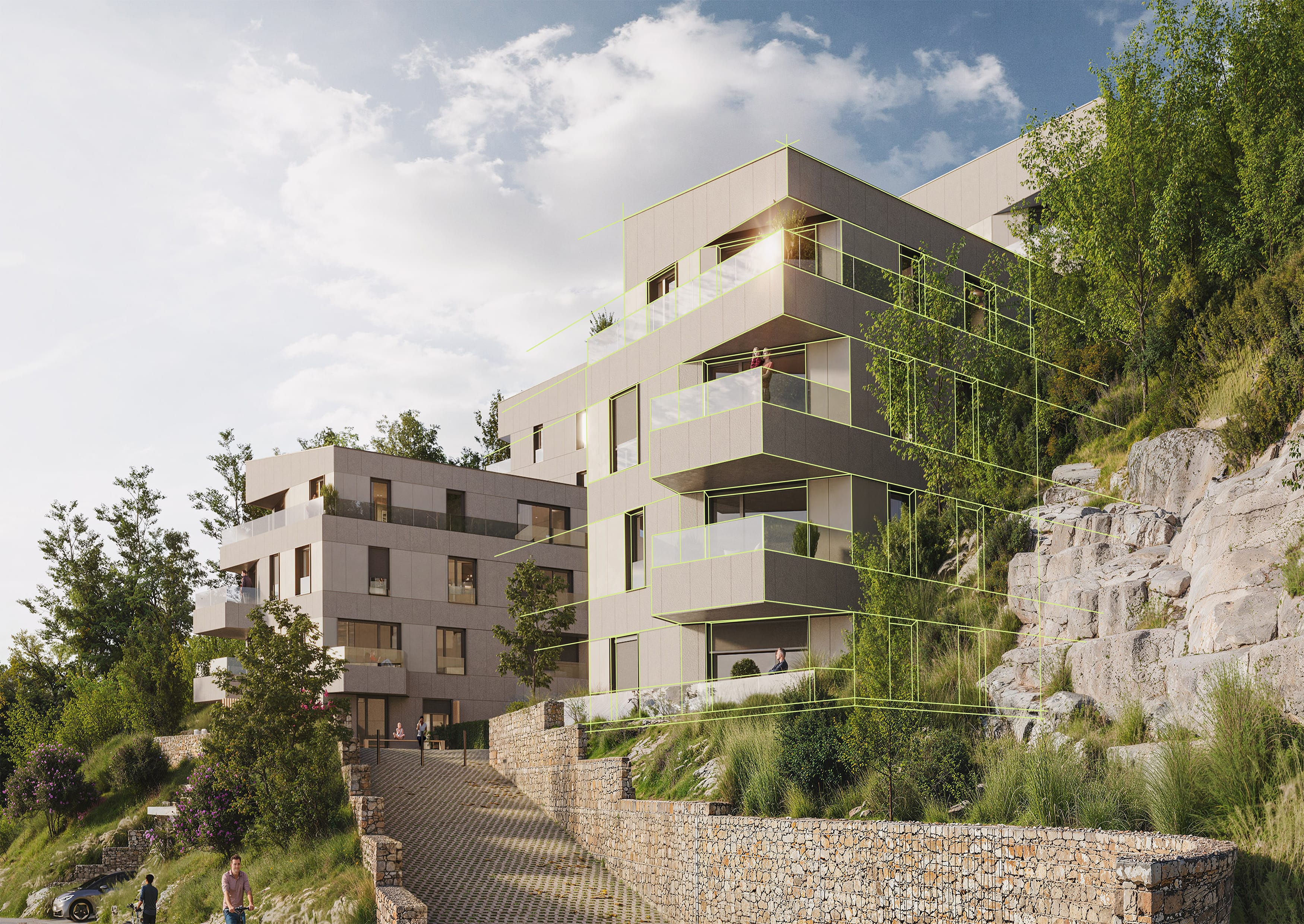 Des immeubles modernes avec de grands balcons sont construits à flanc de colline avec des murs de soutènement en pierre, entourés de verdure et de rochers, sous un ciel partiellement nuageux. Deux personnes et une voiture sont visibles sur le sentier.